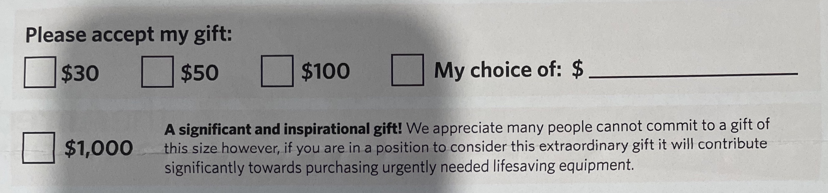 A photograph of a Direct Mail response mechanism with an ask of $1000.